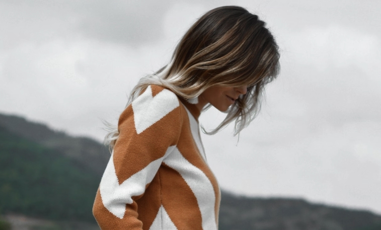 Bottle of Restore Conditioner surrounded by botanical ingredients, representing keratin-rich hair care for strengthening and moisturizing damaged hair.